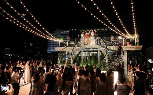 a crowd of people watching a performance at night at Hotel Once Bangkok in Bangkok