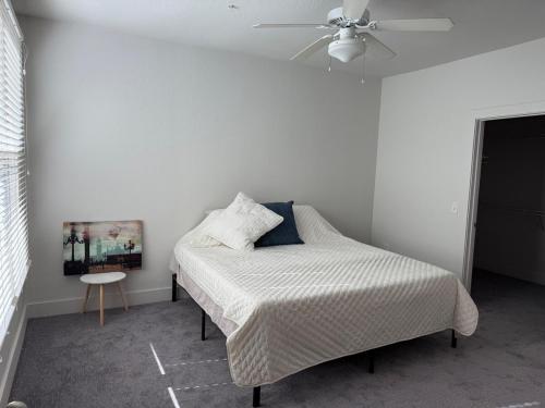 a bedroom with a bed and a ceiling fan at Experience the Best of Fort Worth Stylish Apartment in the Cultural District in Fort Worth