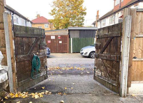 a pair of wooden gates with a green rope on them at Kate House in London