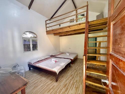 a bedroom with a bunk bed and a ladder at Mount Avangan Eco Adventure Park in Coron