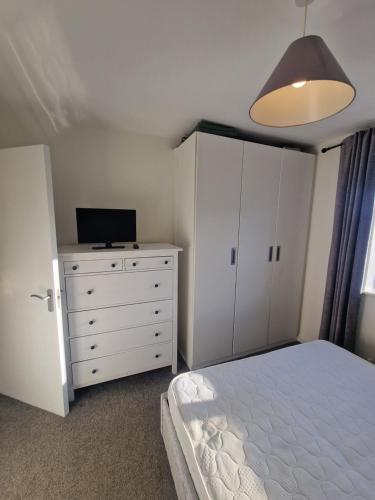 a bedroom with a bed and a tv on a dresser at Citywest 2 Bed Apartment in Citywest