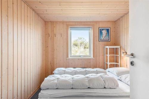 a room with four beds in it with a window at 319-Hvide-Sande-Gammeleng-16 in Hvide Sande