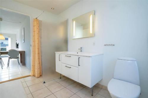 a white bathroom with a sink and a toilet at 769-Hvide-Sande-Norregade-4-C in Hvide Sande