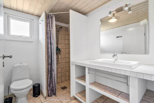 a white bathroom with a sink and a toilet at 355-Hvide-Sande-Fyrmarken-54 in Hvide Sande