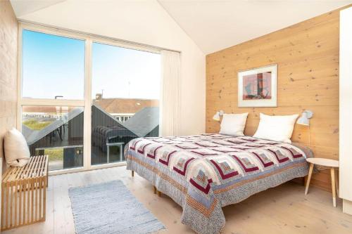 a bedroom with a bed and a large window at 717-Hvide-Sande-Slusen-17 in Hvide Sande