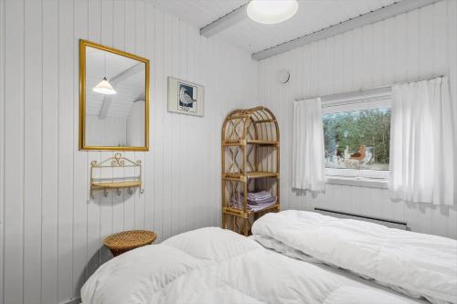 a bedroom with two beds and a mirror and a window at 602-Hvide-Sande-Nygardsvej-32 in Bjerregård
