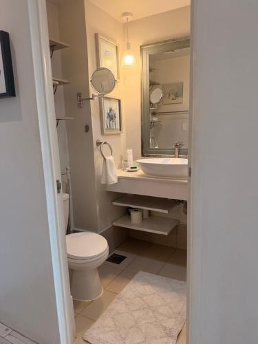 a bathroom with a sink and a toilet and a mirror at Sunvida tower Unit 1911 in front Sm Cebu in Cebu City