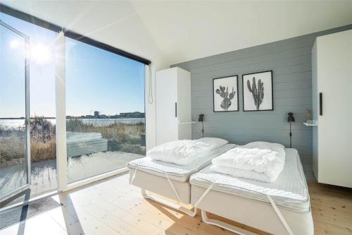 a bedroom with a bed and a large window at 707-Hvide-Sande-Slusen-7 in Hvide Sande