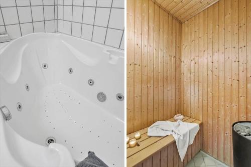 a bathroom with a white tub and a wooden wall at 703-Hvide-Sande-Slusen-3 in Hvide Sande