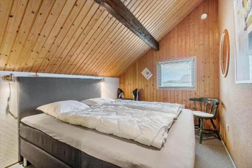 a large bed in a room with a wooden ceiling at 601-Hvide-Sande-Bjerregardsvej-375 in Bjerregård