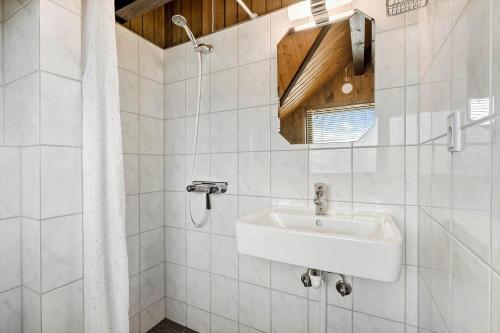 a white bathroom with a sink and a mirror at 601-Hvide-Sande-Bjerregardsvej-375 in Bjerregård