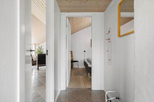 a hallway leading to a living room with a wooden ceiling at 6623-Hvide-Sande-Bilbergsvej-18 in Bjerregård