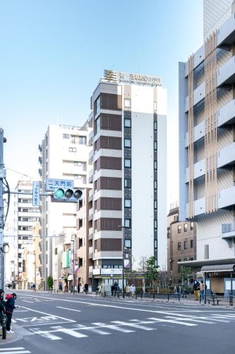 a city street with a traffic light and buildings at 若浅草和心ホテル in Tokyo