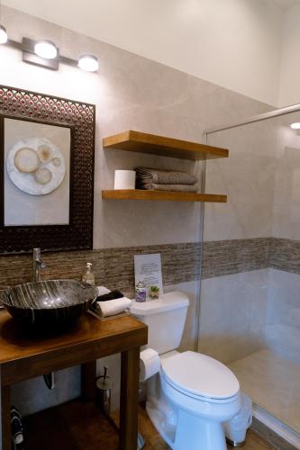 a bathroom with a toilet and a sink at Hacienda Martlot in Ensenada
