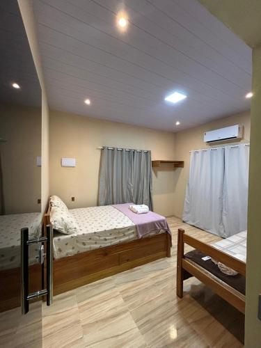 a bedroom with two beds in a room at Loft Marajó Superior in Soure