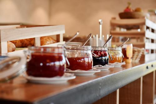 a row of jars of jam on a counter at Landgasthof Kreuz - Der Zwischenstopp mit Herz auf dem Weg in den Süden in Kappel bei Olten