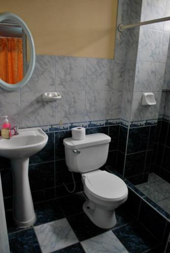 a bathroom with a toilet and a sink at JaimeCrazyhostel in Huarmey