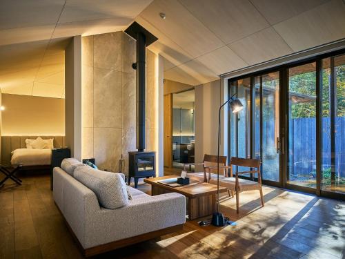 a living room with a couch and a fireplace at Hakone Retreat villa 1/f in Hakone