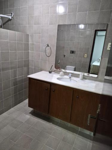 a bathroom with a sink and a mirror at Pousada Aconchego Manaíra in João Pessoa