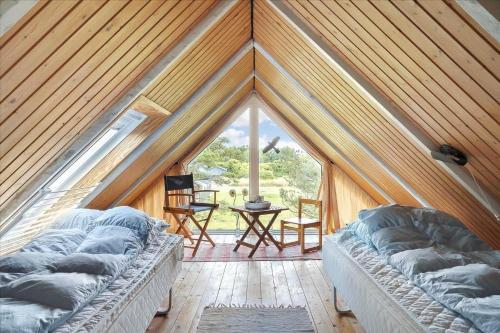 a room with two beds in a tent at 303-Hvide-Sande-Fyrmarken-36 in Hvide Sande