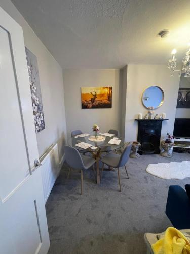 a living room with a table and chairs and a fireplace at Amazing Central Windsor Flat Contractors welcome in Windsor
