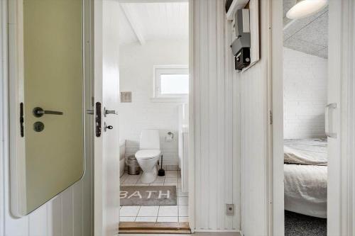 a bathroom with a toilet in a room at 621-Hvide-Sande-Dortheasvej-8 in Bjerregård