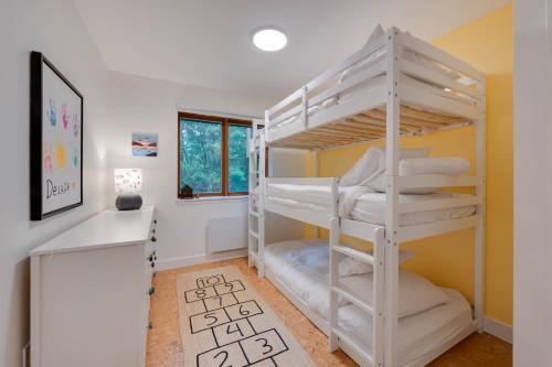 a room with two bunk beds and a desk at Unité 17 - Ski-in Ski-out in Beaupré