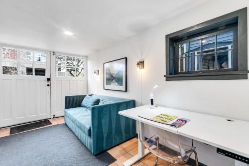 a living room with a blue couch and a table at The Montlake Spite House in Seattle