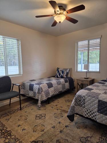 a bedroom with two beds and a ceiling fan at Quiet Desert Oasis off Swan Rd in Tucson