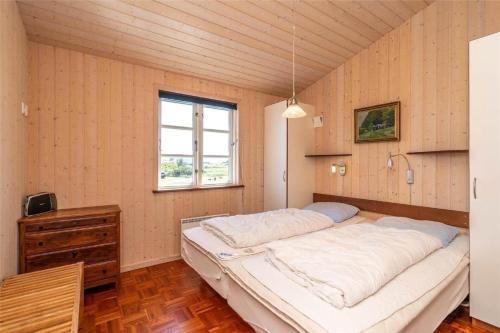 a large bed in a room with a window at 439-Hvide-Sande-Tingodden-120 in Hvide Sande