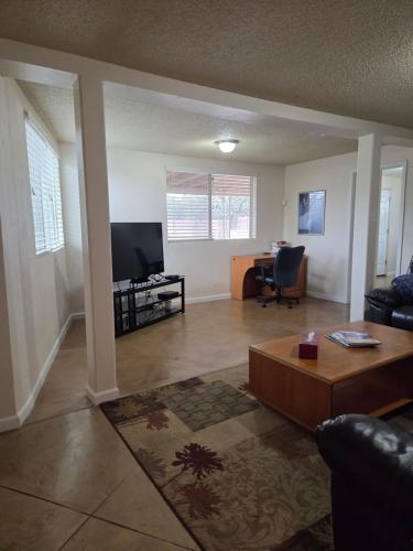 a living room with a couch and a tv at Quiet Desert Oasis off Swan Rd in Tucson