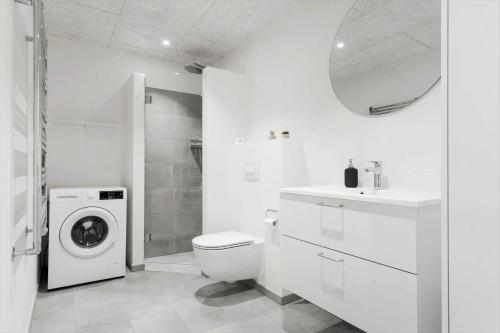 a white bathroom with a washing machine and a sink at 771-Hvide-Sande-Norregade-2-nr-28 in Hvide Sande