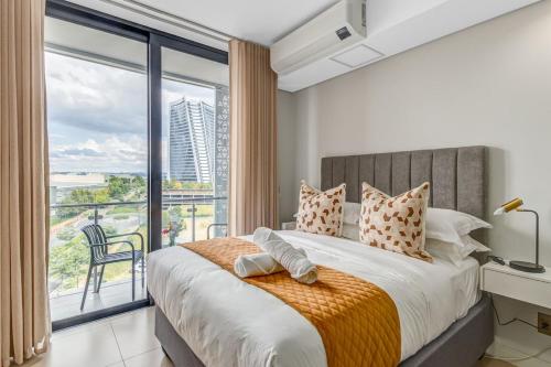 a bedroom with a large bed with a large window at Serene Spaces, Ellipse in Midrand