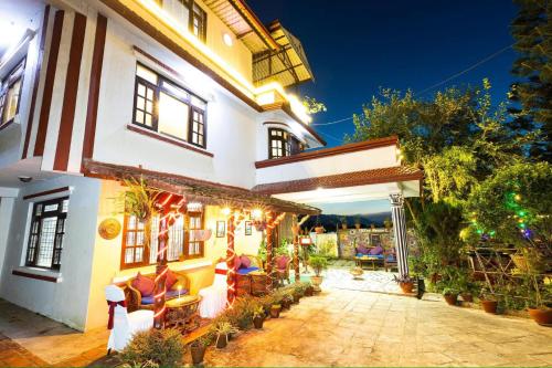 a house with an outdoor patio at night at D Eco Resort in Dhulikhel