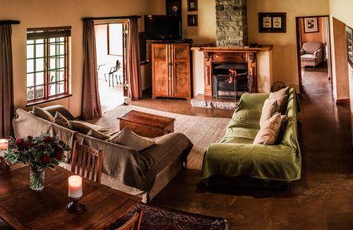 a living room with a couch and a table at The FarSide Dam Cottage in Nottingham Road