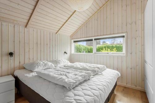 a bedroom with a bed in a room with a window at FA066-Faxe-Ladeplads-Engsvinget-5 in Fakse Ladeplads