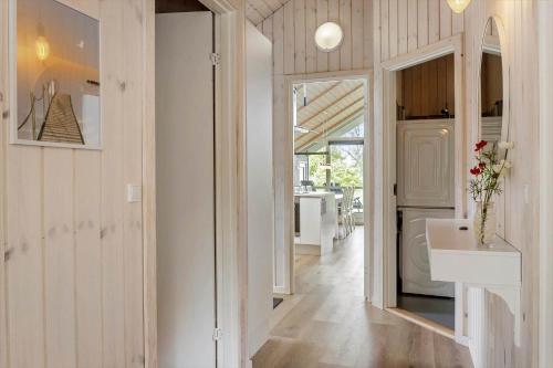 a bathroom with a sink and a mirror and a hallway at FA066-Faxe-Ladeplads-Engsvinget-5 in Fakse Ladeplads