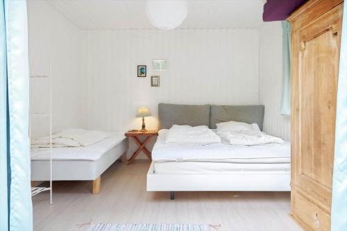 a bedroom with two beds and a table with a lamp at 2002-Stege-Solvgranen-7 in Stege