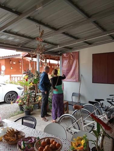 a couple of people standing in a room at K Khan Chiang Khan Walking Street Garden Home in Chiang Khan