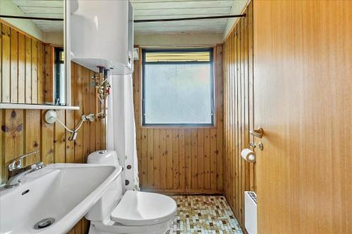 a bathroom with a white toilet and a sink at 1055-Stege-Rylevej-21 in Stege