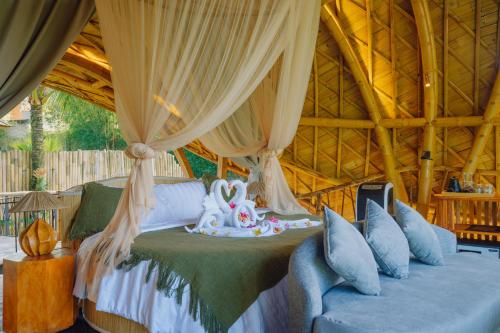 a bedroom with a bed in a tent at Astha Bamboo House in Sidemen