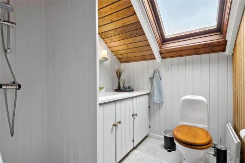 a bathroom with a toilet and a sink and a window at 8206-Vordingborg-Havstokken-6 in Vordingborg