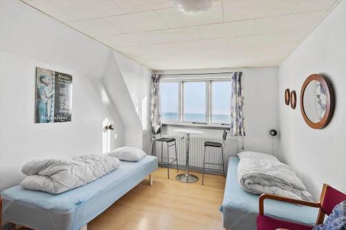 a room with two beds and a table in it at 8211-Mern-Havnen-4 in Mern