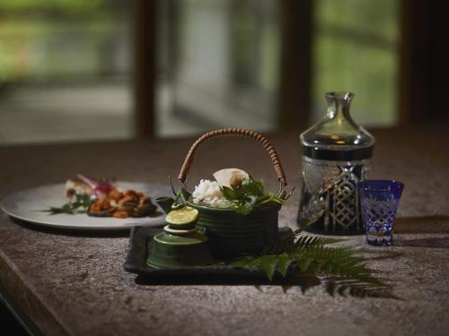 a table with a basket of food and a plate of food at Hakone Retreat villa 1/f in Hakone