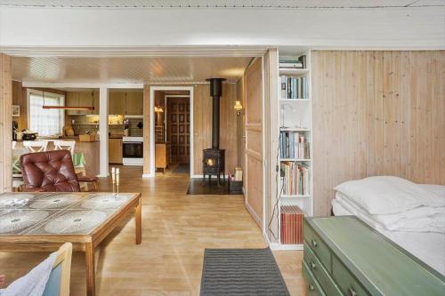 a room with a bed and a living room with a table at 5015-Askeby-Gormsvej-5 in Askeby
