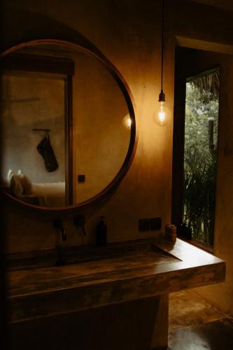 a bathroom with a large mirror on the wall at RONJA Boutique Hotel - Adults Only in Uluwatu