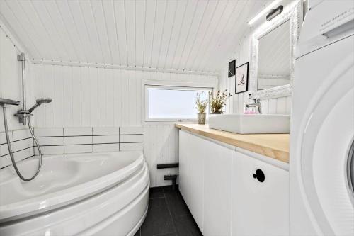 a white bathroom with a toilet and a sink at S746-Stroby-Ladeplads-Lovsangervej-6 in Strøby Ladeplads