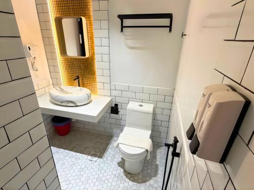 a bathroom with a toilet and a sink at Seeds Hotel Damansara Pelangi in Petaling Jaya