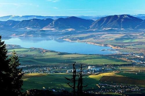 a view of a valley with a body of water at Tatralandia Apartmán in Liptovský Mikuláš