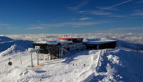 a building on the top of a snow covered mountain at Tatralandia Apartmán in Liptovský Mikuláš